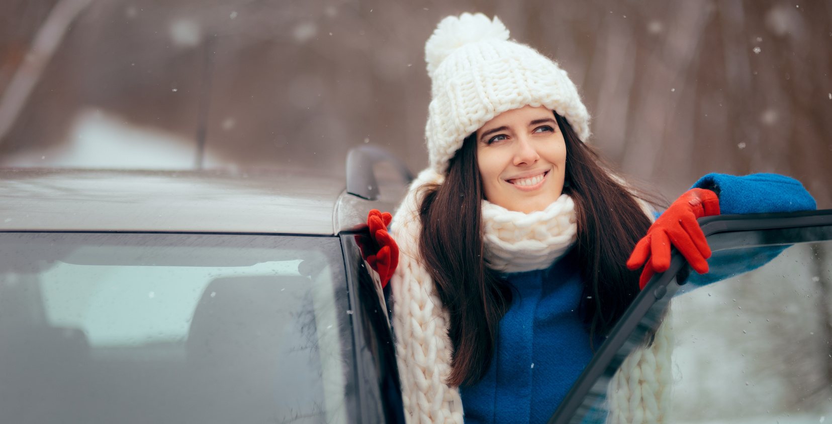 Woman standing outside of her car