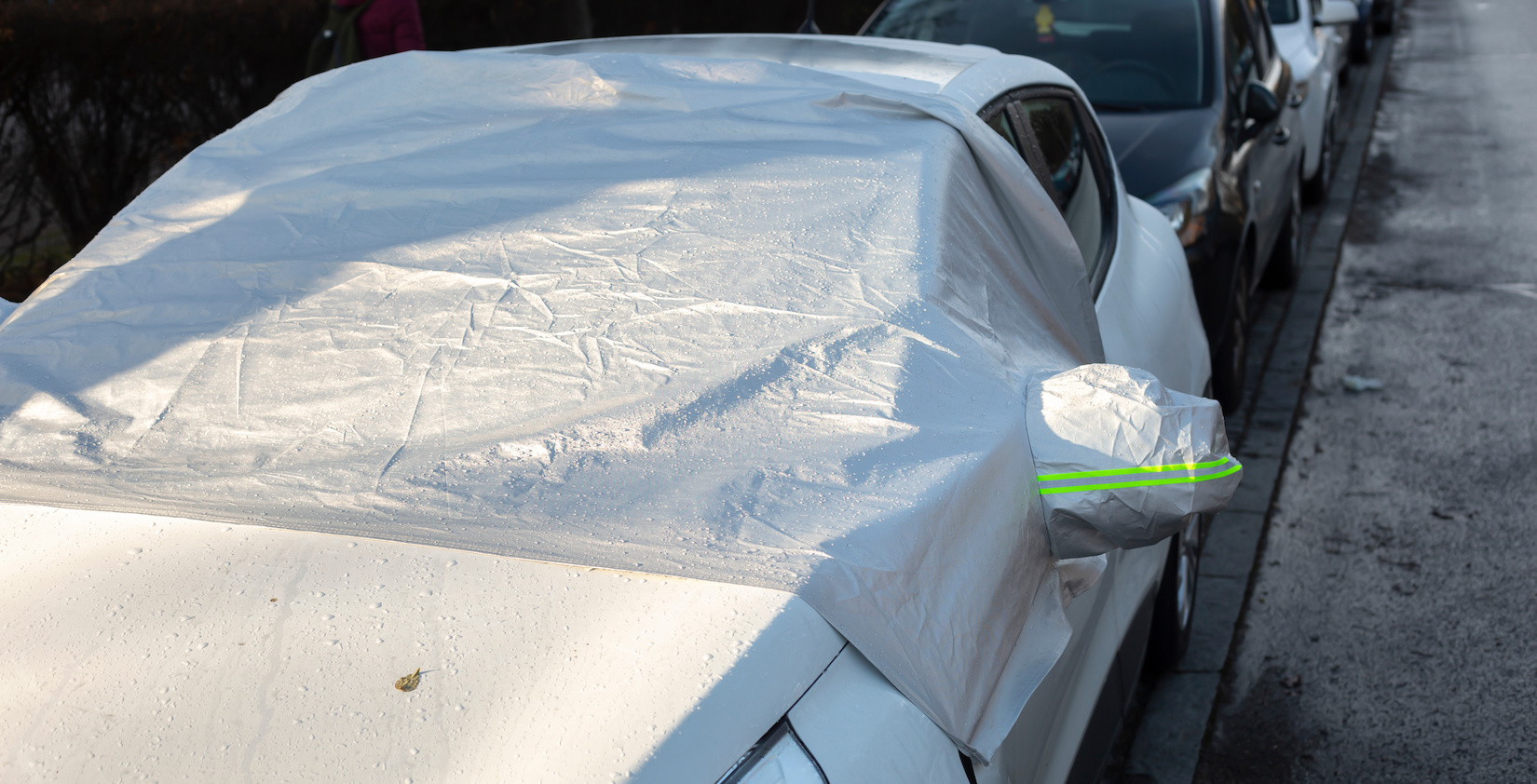Front of a car covered with a tarp